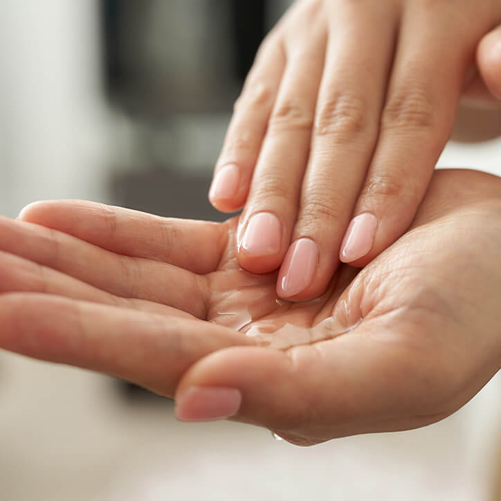 Frau hat Massageöl in den Händen